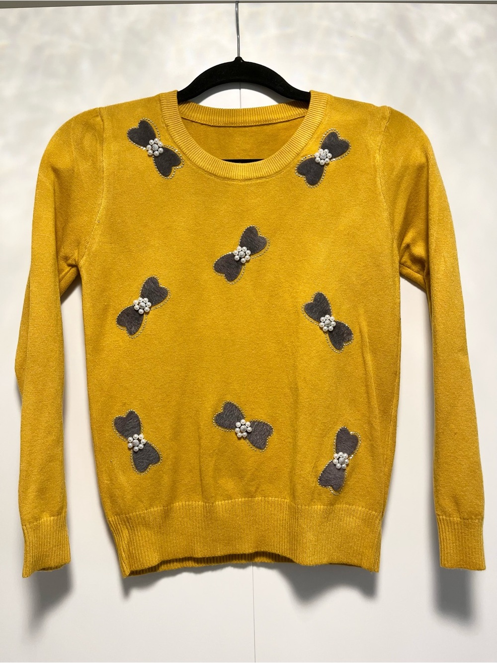 Yellow sweater with grey felt and pearl bow detail